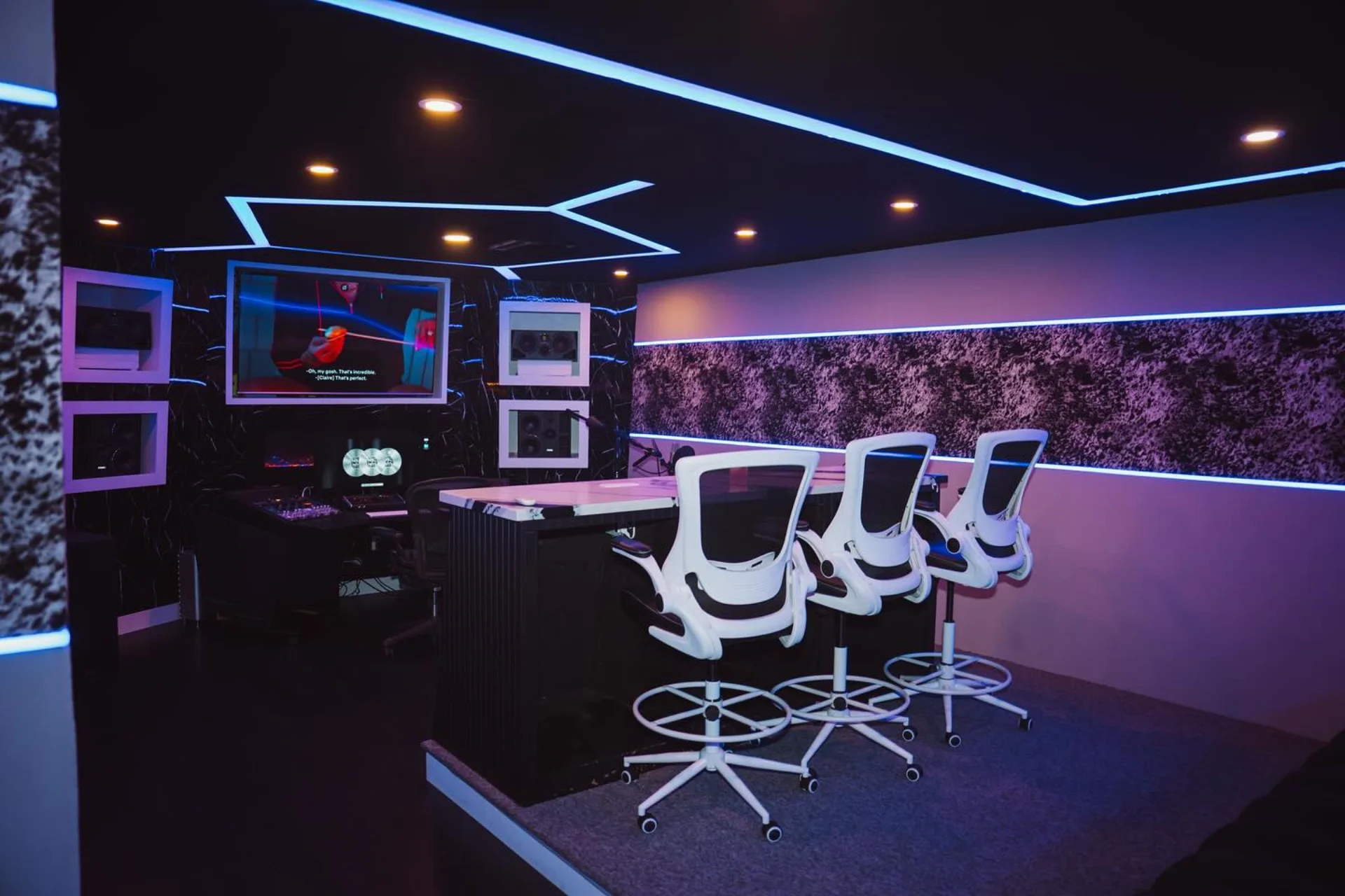 Spacious Hall of Hits collaboration room with desk seating and illuminated walls