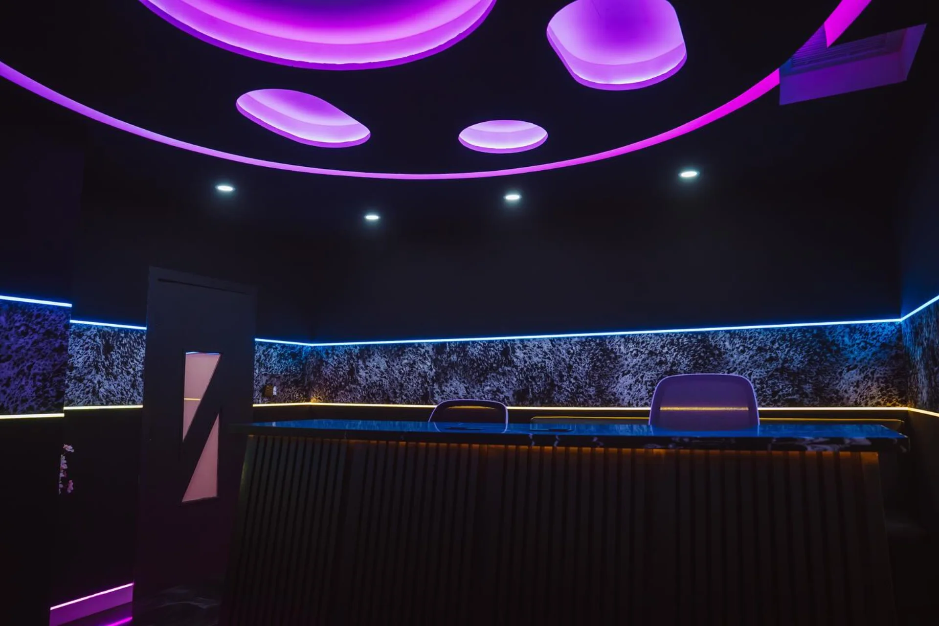 Purple-lit Studio B production room and lounge